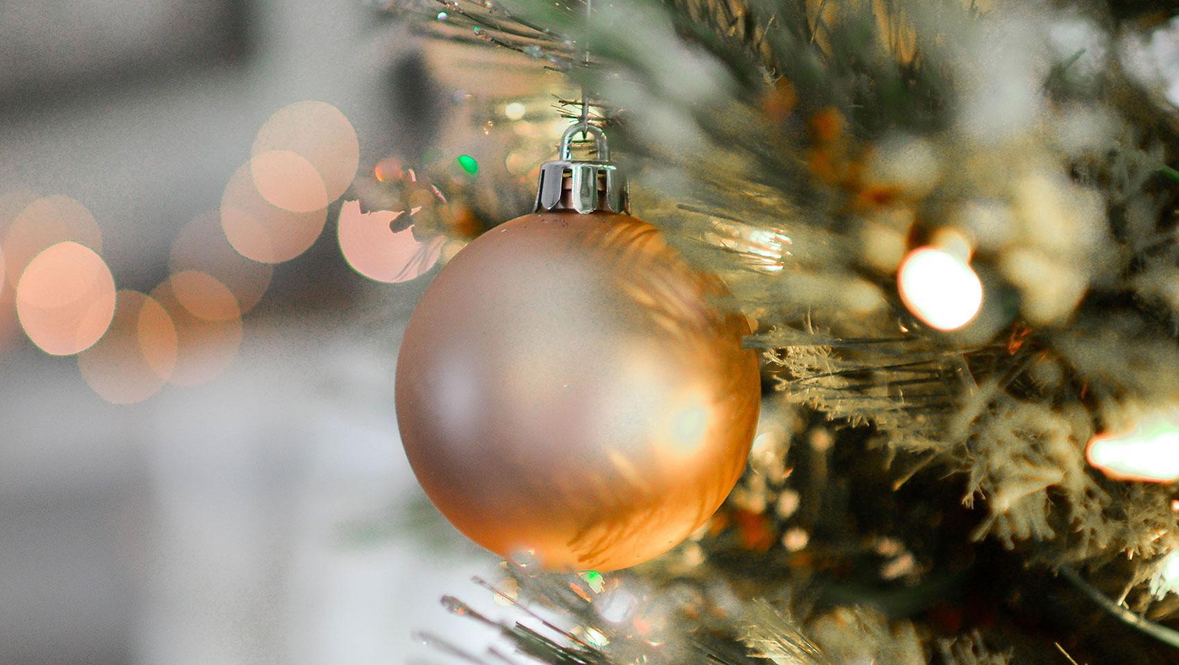 gold ornament on an evergreen bough