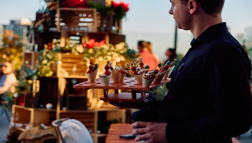 waiter with tray of snacks at Tinseltown Hollywood Market