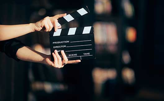 hands holding a clapperboard
